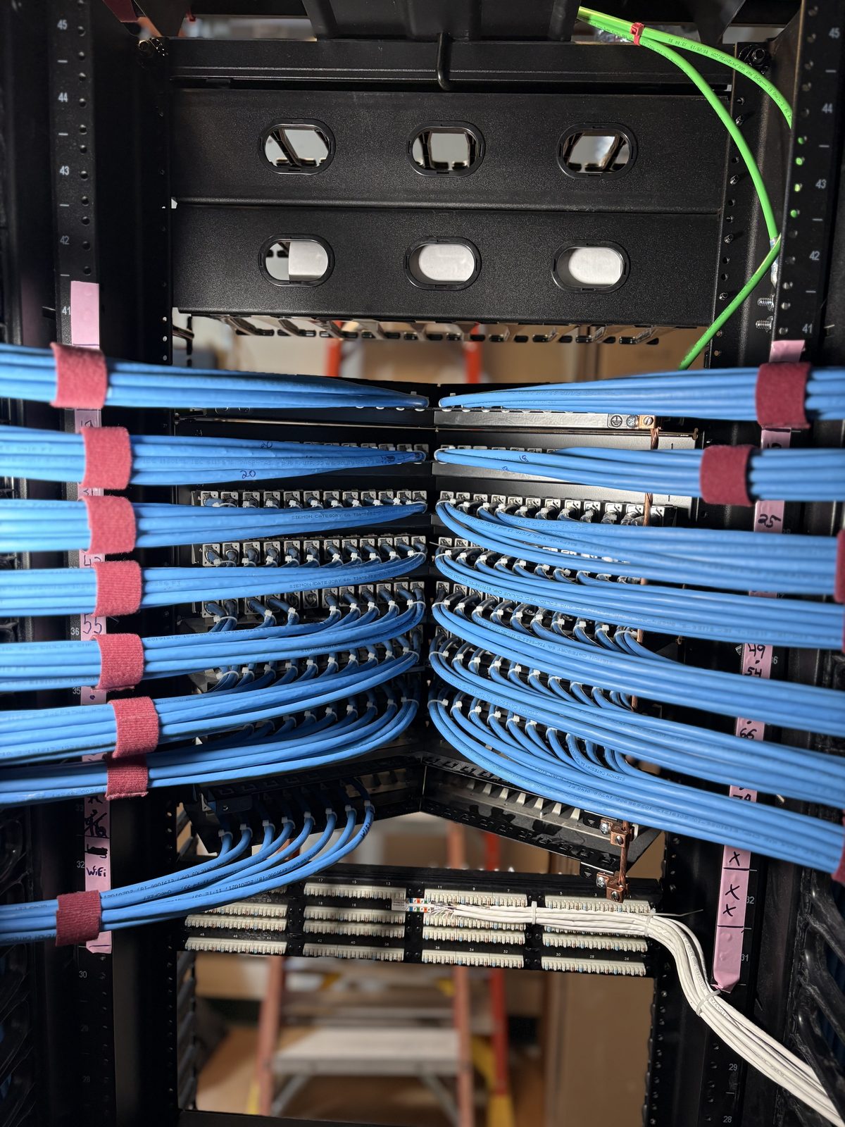 High-density Cat6A patch panel terminations at the back of a rack