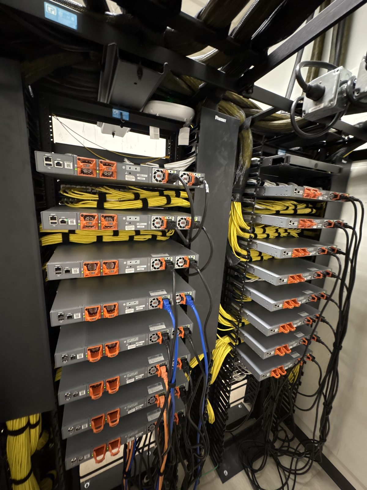 Back-of-rack switch power supplies and dressed yellow cabling