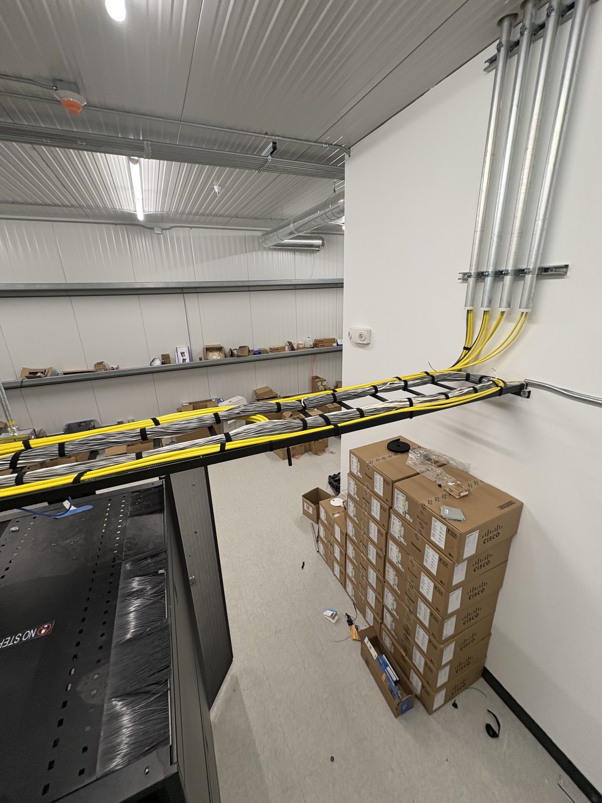 Long cable-tray pathway of bundled cable across a server room