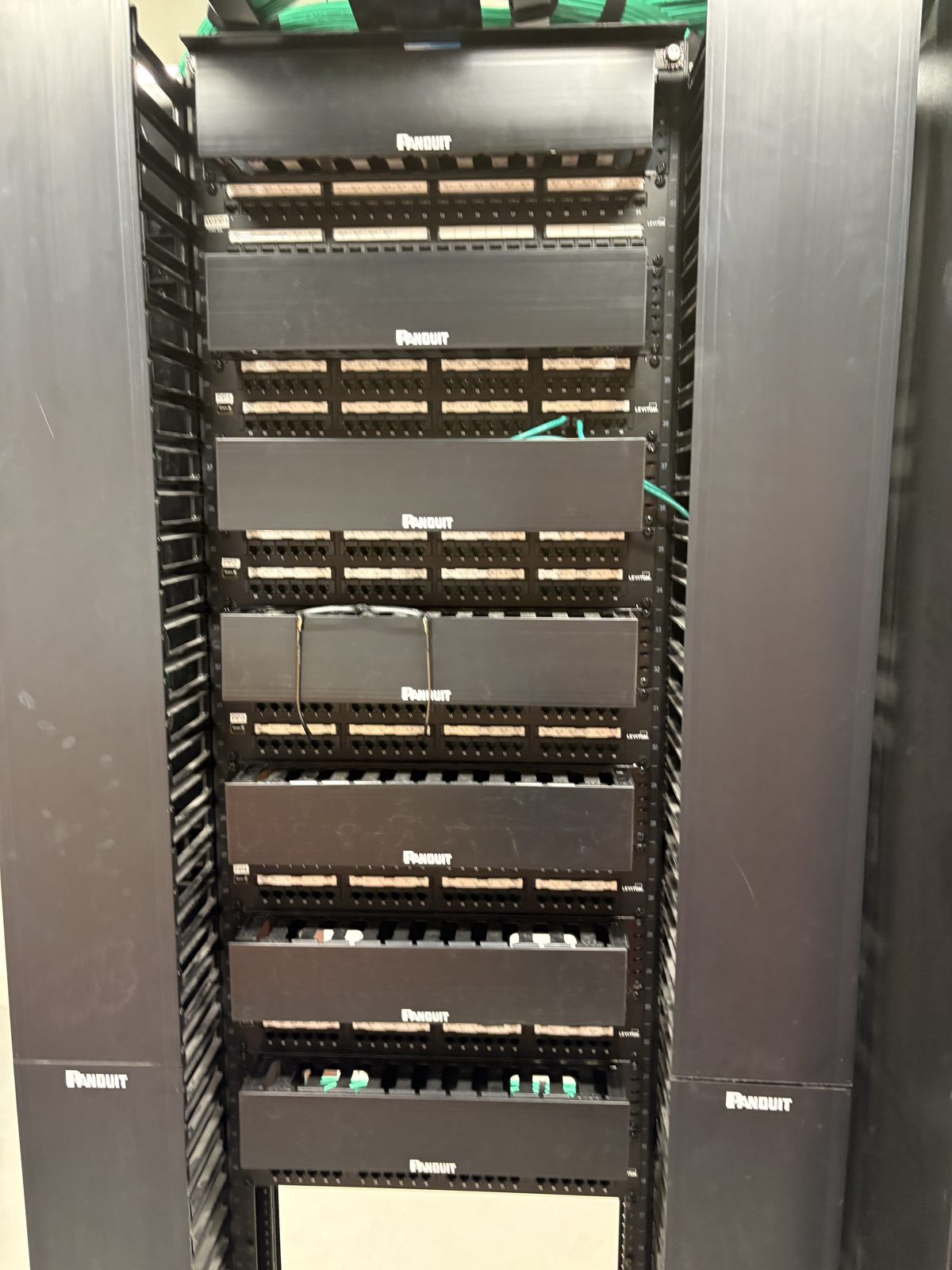 Stacked Panduit and Leviton patch panels, front of rack