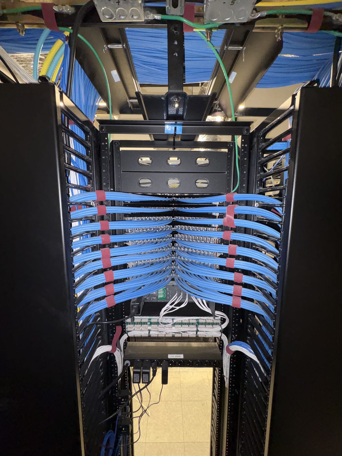Rebuilt rack with combed Cat6 patch runs into high-density patch panels