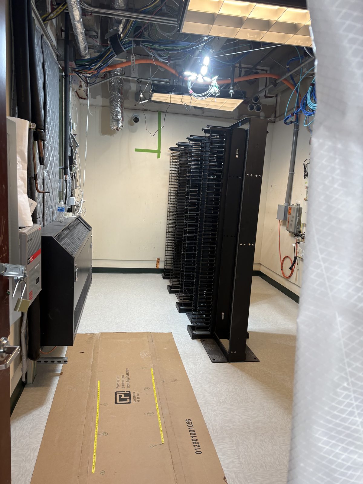 Finished room with new floor-mounted vertical cable managers installed